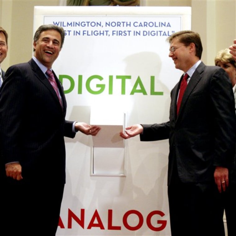 Wilmington Mayor Bill Saffo, left, and Kevin Martin, then chairman of the Federal Communications Commission, flip a symbolic switch during a news event heralding the switch from analog to digital television signals in Wilmington, N.C. 